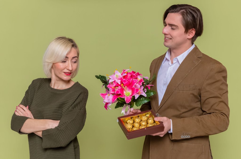young-beautiful-couple-happy-man-giving-box-chocolate-candies-bouquet-flowers.jpg