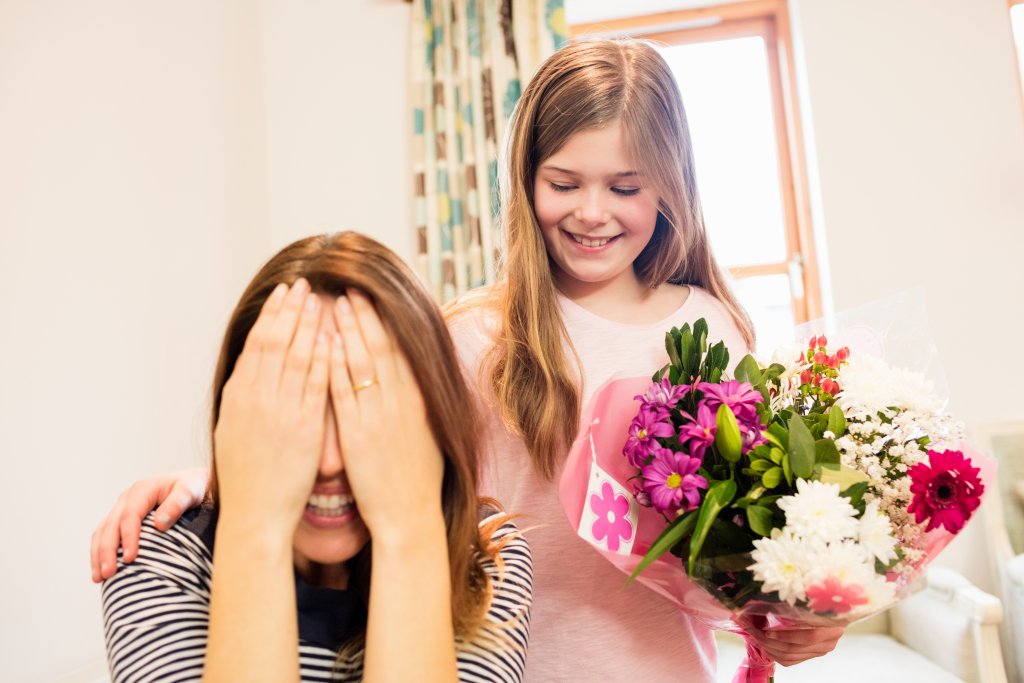 mother-covering-her-eyes-while-receiving-gift-from-daughter.jpg mother-covering-her-eyes-while-receiving-gift-from-daughter.jpg