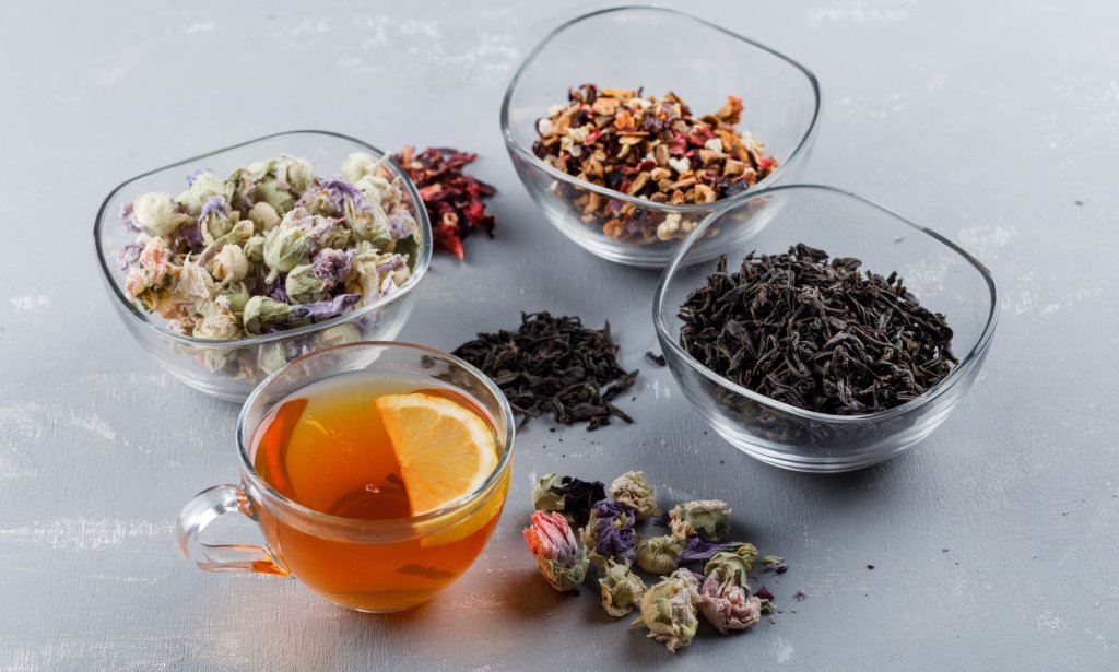 assorted-dried-herbs-with-cup-tea-glass-bowls-plaster-surface2.jpg