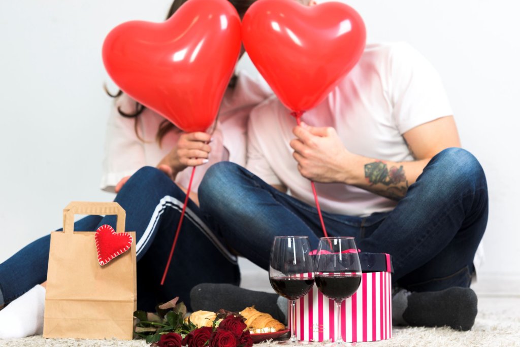 couple-covering-faces-with-red-heart-balloons.jpg couple-covering-faces-with-red-heart-balloons.jpg