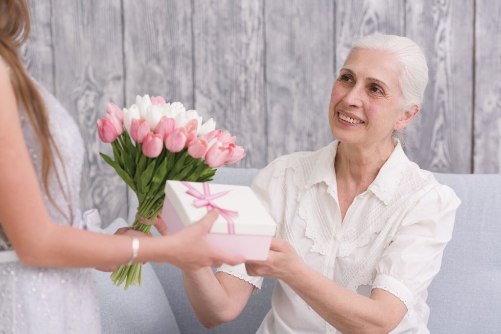 smiling-elder-woman-receiving-flower-bouquet-and-gift-box-front-her-grandchild.jpg smiling-elder-woman-receiving-flower-bouquet-and-gift-box-front-her-grandchild.jpg